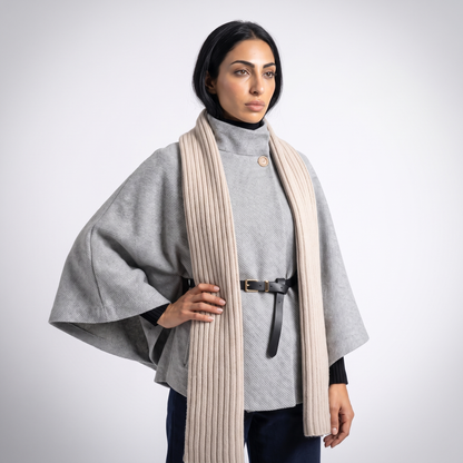 Grey cape sleeve poncho, detail of the gold button high neck