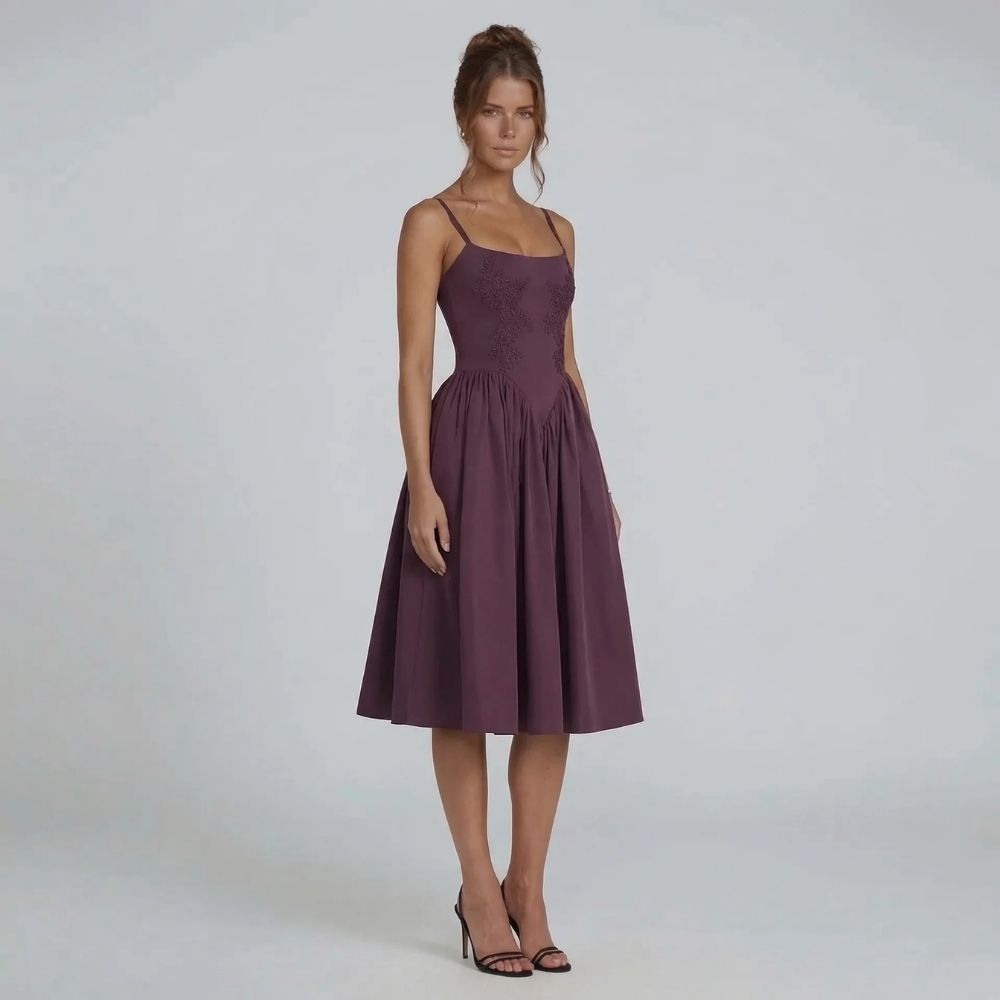 Purple lace midi dress, side view showing the spaghetti straps and pleated skirt