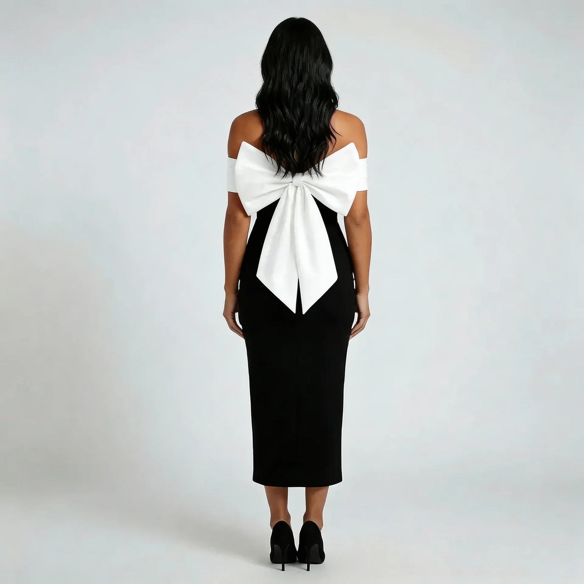 Black off shoulder midi dress, back view showing the dramatic bow