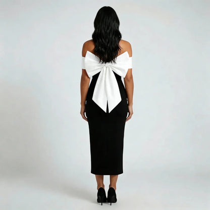 Black off shoulder midi dress, back view showing the dramatic bow
