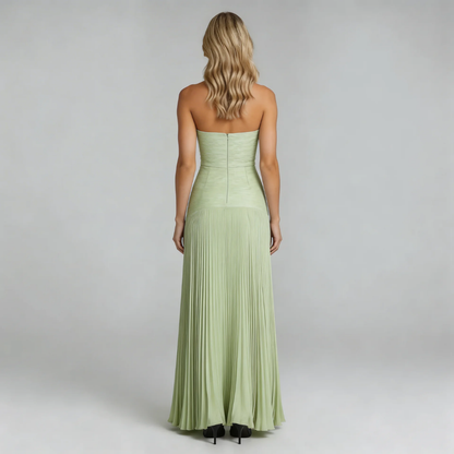 Sage green pleated maxi dress, back view showing the zip closure and pleated skirt